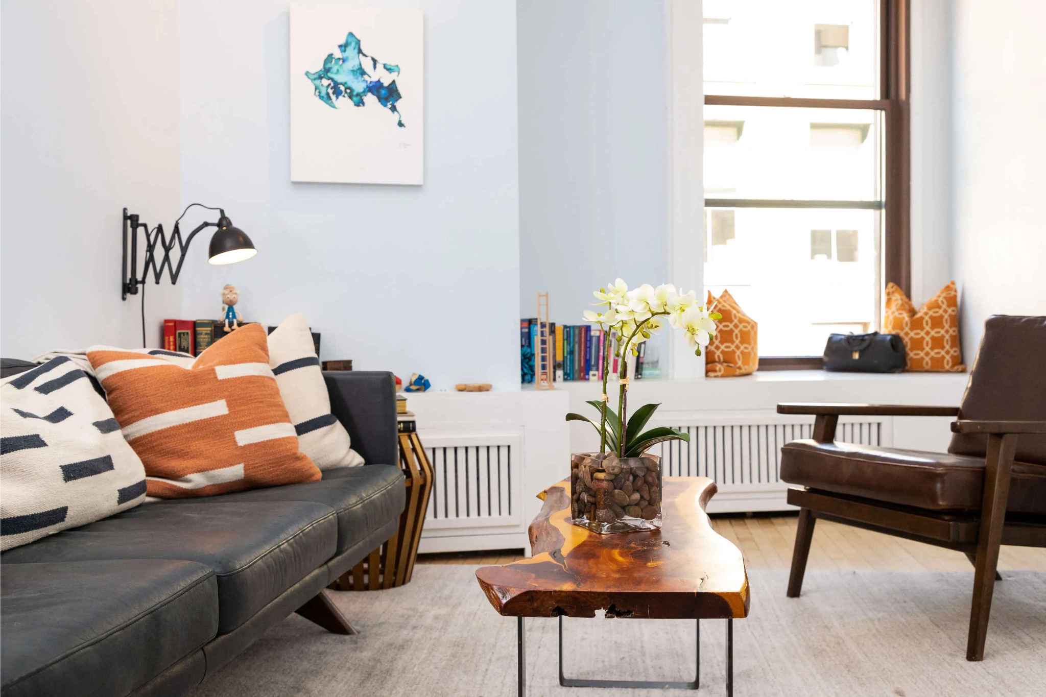 Example office space — therapy room with natural light, leather sofa, live-edge coffee table